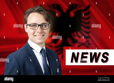 News anchor, tells the latest news, smiling, against the background of the flag of Albania ...