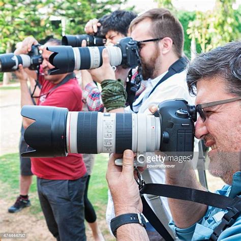 11 Paparazzi Using Flash Photography Along Red Carpet Stock Photos