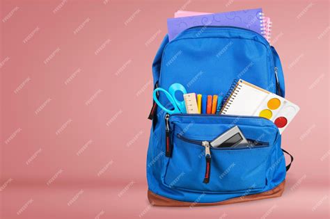 Premium Photo | Open blue school backpack on desk