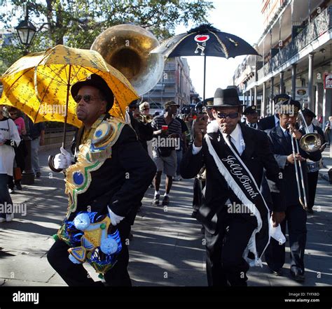 Dancers With Parasols Lead A Jazz Funeral Through The Heart Of New