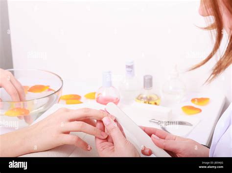 Beautician With File Filing Nails Female Client Woman Spa Beauty Salon