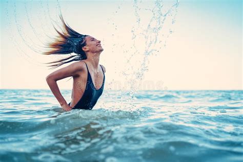 Beauty Model Girl Splashing Water With Her Hair A Young Woman I Stock