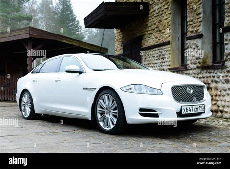 White jaguar car in a village Stock Photo - Alamy