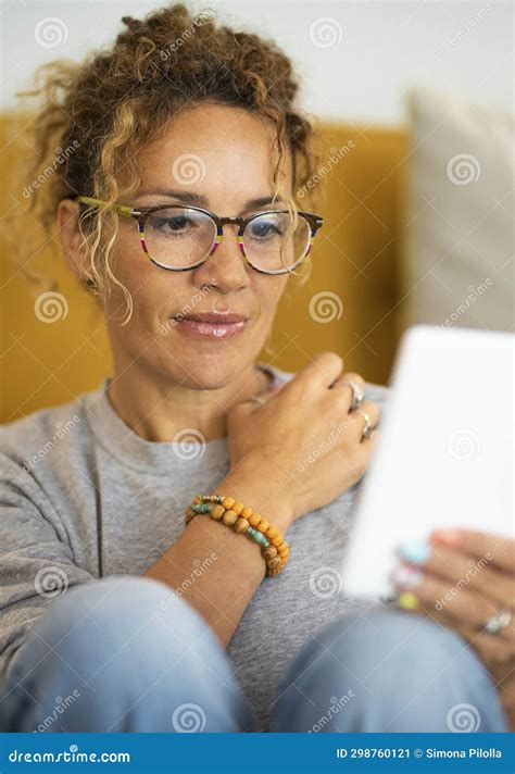 Happy Relaxed Adult Cute Woman Use Electronic Device Reader To Read An E Book And Enjoy Her