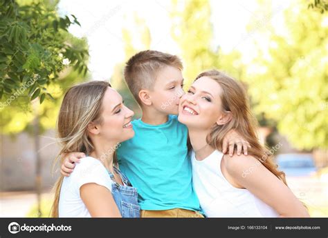 Lesbian Mothers And Foster Son Having Fun Outdoors Stock Photo