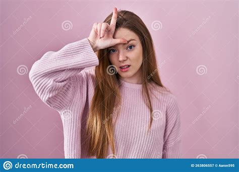 Young Caucasian Woman Standing Over Pink Background Making Fun Of