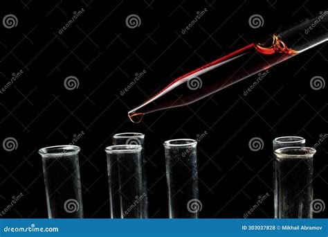 Dripping Liquid From Pipette Into Test Tube In Laboratory Closeup