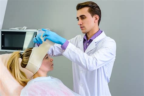 Plastic Surgery Doctor Patient Inspection And Consultation Stock Photo