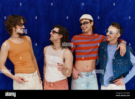 Stylish Jolly Attractive Gay Men With Sunglasses In Vivid Attires Posing On Blue Backdrop Pride