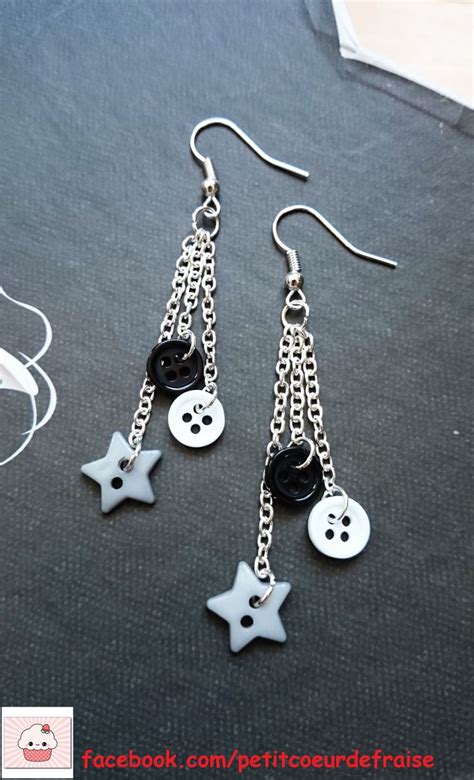 Two Pairs Of Earrings With Buttons And Chains Hanging From Them On A