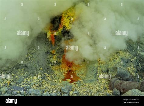 Molten sulfur dripping from pipes at Kawah Ijen volcano, East Java ...