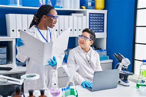 African American Mother And Son Scientists Smiling Confident Using