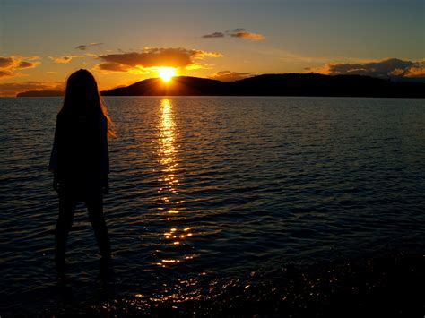 girl-staring-across-the-lake-into-the-sunset image - Free stock photo