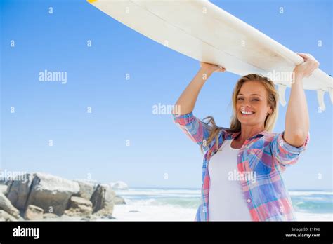 Blonde Surfer Holding Her Board Smiling At Camera Stock Photo Alamy