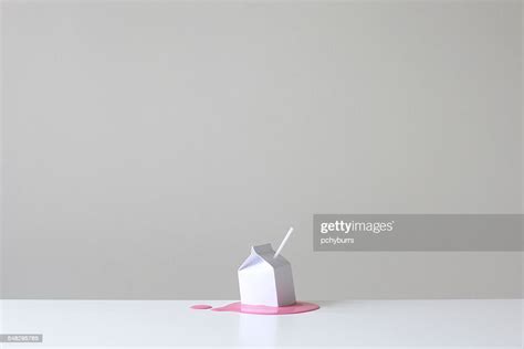 Conceptual Milk Carton With Straw On A Pool Of Pink Strawberry Millk