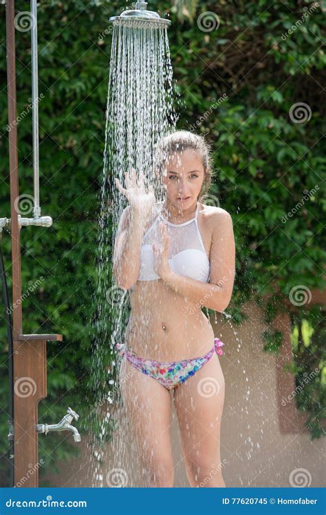 Girl Wear Bikini Standing Under The Outdoor Pool Shower Stock Image