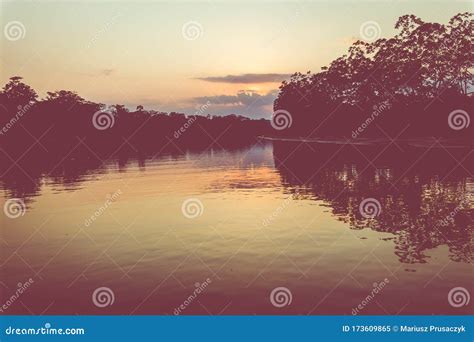 Amazon Rainforest Sunset During A Boat Trip With A Reflection Of The