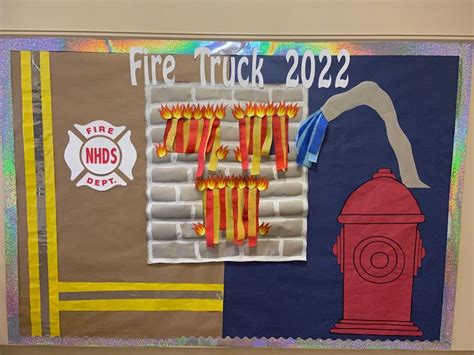 A Bulletin Board With Fire Trucks On It And Paper Streamers Hanging