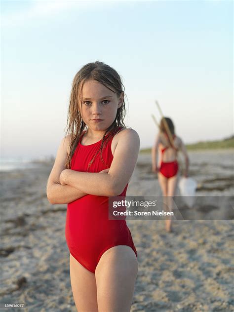 Girl Standing On Sandy Beach High-Res Stock Photo - Getty Images