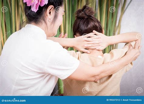 Thai Spa Masseur Is Stretching Women Shoulder In Thai Massage Stock