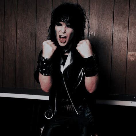 A Woman With Black Hair And Leather Clothes