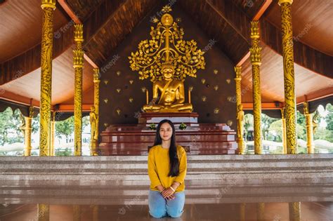 Premium Photo Asian Woman Sitting Meditation And Golden Buddha Statue