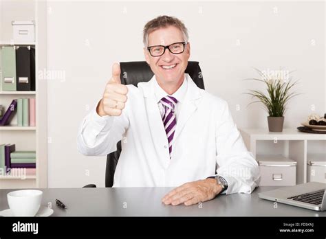 Happy Medical Doctor Showing Thumbs Up At Hand Emphasizing Well Job