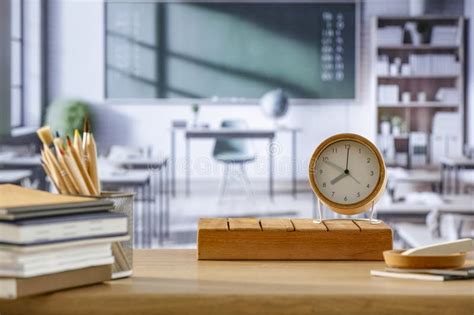 School Stuff And Alarm Clock On Wooden Desk Top In Classroom School Interior Copy Space For