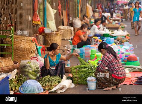 Burmese Female Street Vendors Selling Food And Goods On The Ground At