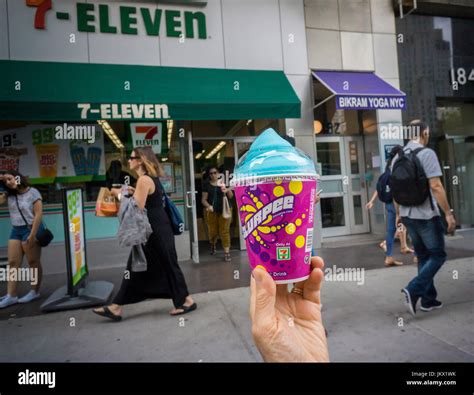 A Slurpee Lover Displays Her Free Drink Outside A 7 Eleven Store In New