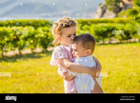 Portrait Of Two Cute Adorable Baby Children Toddlers Hugging And