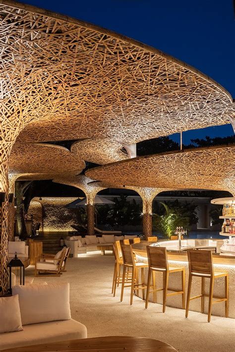 An Outdoor Restaurant Is Lit Up At Night With Wicker Covering The