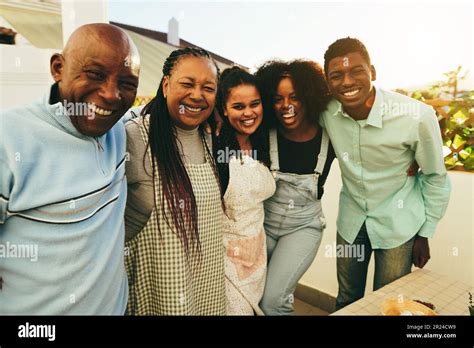 Happy african family cooking together in outdoor kitchen at home ...