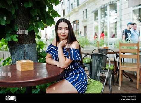 Gorgeous Brunette Girl Sitting On The Table In Cafe Stock Photo Alamy