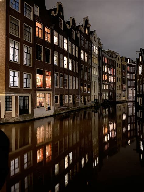 Brown And White Concrete Building Near Body Of Water During Daytime Photo Free Water Image On