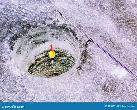 A Float Sits in a an Ice Fishing Hole. Stock Image - Image of arctic ...