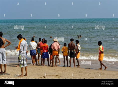 Tourists Enjoying The Sand Ocean On The Tiruchendur Beach Stock Photo