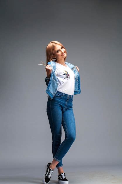Premium Photo Beautiful Sexy Blonde Woman Dressed In A Denim Jacket And Blue Jeans Fashion