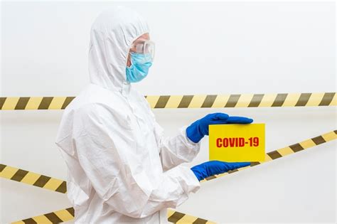 Free Photo | Man in hazmat suit with covid-19 sign