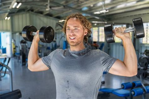 Fitness Man Doing Military Presses Or Standing Dumbbell Press Exercise