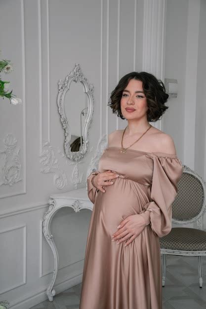 Premium Photo Pregnant Woman In A Beige Dress