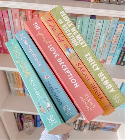 There Are Many Books Stacked On Top Of Each Other In Front Of A Book Shelf