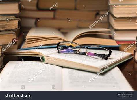 Open Book And Glasses On Wood Desk In The Library Room With Narrow