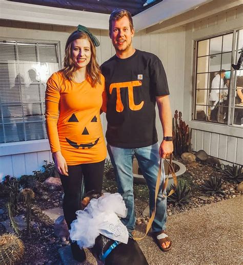 a man and woman standing next to each other in front of a house ...