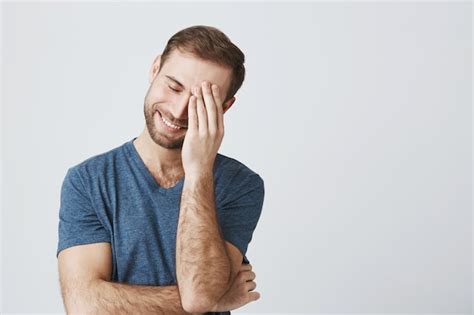 Free Photo Smiling Man Facepalm After Embarrassing Joke