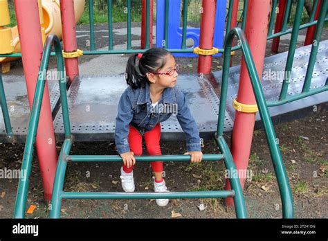 Year Old Latina Brunette Girl With Eye Glasses Plays In The Playground As Therapy For