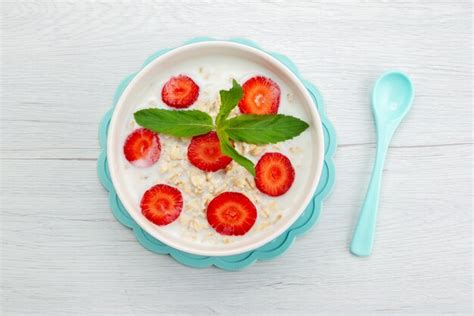 Free Photo Top View Milk With Oatmeal Inside Plate With Strawberries