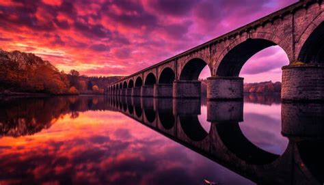 Premium AI Image | a bridge over a lake with a pink sunset in the ...