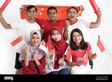 Singapore Flag Day. Young joyful group of people holds Flag of ...