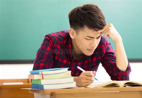 Stressed Student Studying For Exam In Classroom Stock Photo Image